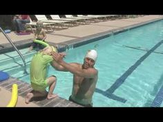 a man and child are playing in the pool