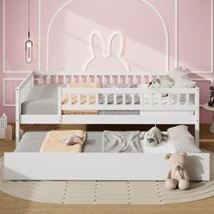 a child's bedroom with pink walls and white furniture