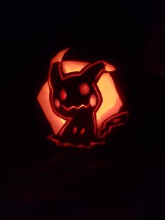 a pumpkin carved to look like a pokemon pikachu with an evil face on it