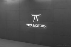 the tata motors logo is lit up on a wall