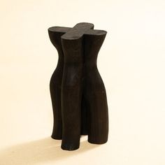 two wooden vases sitting side by side on a white surface, one is black and the other is brown