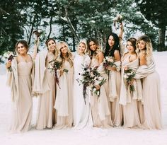 a group of women standing next to each other in the snow