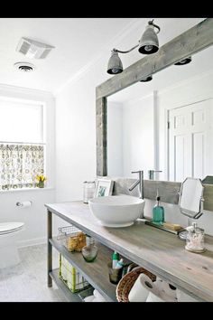 a bathroom with a sink, mirror and toilet