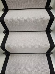 the carpeted stairs are lined with black and white stripes, which give them an interesting effect