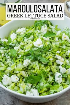 a white bowl filled with lettuce and feta cheese