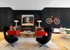 a living room filled with furniture and a bike mounted to the wall above it's fireplace