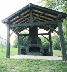 an outdoor fireplace in the middle of a field