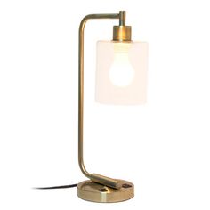 a table lamp with a white glass shade on the base and a gold metal stand