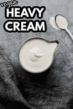 vegan heavy cream in a small bowl with spoons next to it on a gray background