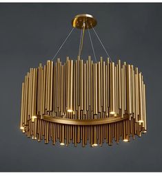 a gold chandelier hanging from the ceiling with many lights on top of it