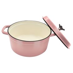 a pink casserole with a black lid and spoon in front of it on a white background