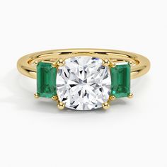 Lab Grown Luxe Rhiannon Three Stone Lab Emerald Engagement Ring - 18K Yellow Gold. Two luxurious lab emeralds rest alongside the center gemstone in this classic, sophisticated ring. Rose Gold Emerald Ring, Cushion Cut Diamond Engagement Ring, Emerald Ring Gold, Lab Diamond Engagement Ring, Cushion Cut Ring, Emerald Engagement, Yellow Gold Setting, Cushion Cut Diamonds, Emerald Engagement Ring