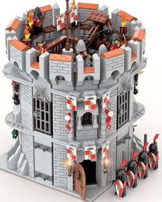 a castle made out of legos with lots of red and white flags on it