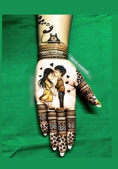 a woman's hand painted with henna and an image of a man kissing her