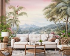 a living room filled with furniture and wallpaper covered in tropical trees on the walls