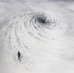 an aerial view of a man walking in the middle of a snow storm with a black and white swirl