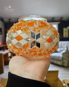 Hand holding mosaic glass globe with orange, white, and mirrored mosaics, showcasing artistic brilliance. Lipan Art, Cut Glasses, Turkish Lights, Lamp Diy, Diy Mosaic, White Mosaic