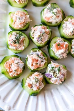 cucumbers stuffed with crab salad and dill pickles on a white plate