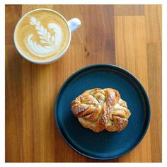 a pastry on a plate next to a cup of coffee