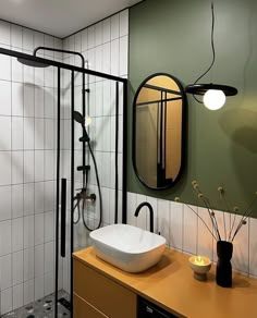 a bathroom with a sink, mirror and stand up shower in the middle of it