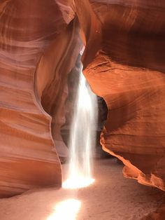 a small waterfall cascading into the side of a canyon