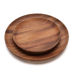 two wooden plates sitting on top of each other