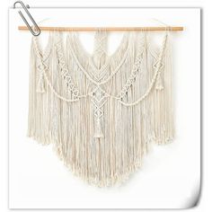 a macrame hanging on a clothes line with some clips attached to the hanger