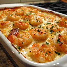 a casserole dish filled with shrimp and cheese