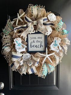 a wreath that says you me and the beach with starfishs, seashells and flip flops on it