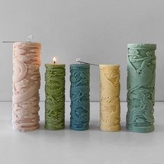 four different colored candles sitting next to each other