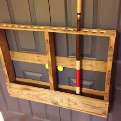 a baseball bat and ball in a window frame on the front door of a house