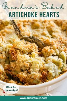 a casserole dish filled with artichoke hearts and topped with crumbs