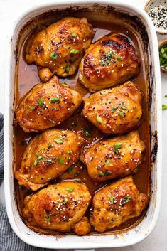 baked chicken thighs in a baking dish with herbs