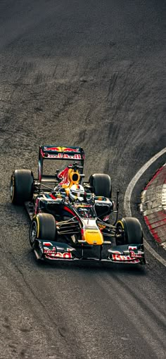 two red and yellow race cars racing on a track