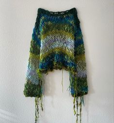 a knitted sweater hanging on the wall