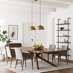 a dining room table and chairs in front of a white brick wall with hanging lights