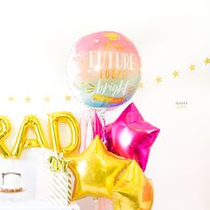 some balloons that are sitting next to each other on a table with the words rad