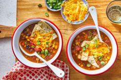 two bowls of chili soup on a wooden table