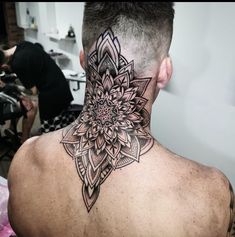 a man with a tattoo on his back neck