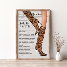 a poster with a woman's legs and leopard print in front of a white wall