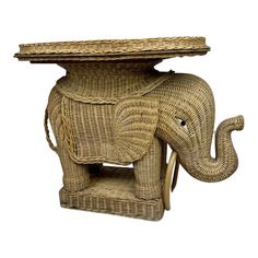 an elephant shaped wicker table with its trunk resting on it's back end