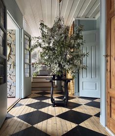 a room with a checkered floor and potted plant