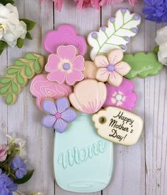 decorated cookies in a mason jar with flowers