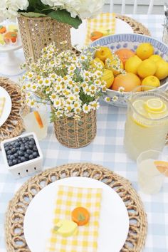 the table is set with plates and bowls of fruit