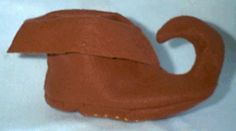 a brown hat is sitting on a white surface