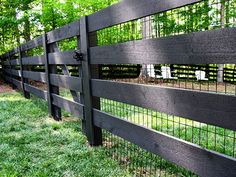 a black fence is shown in the grass