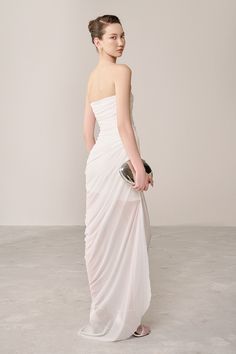 Expertly crafted from a blend of organza and spandex, this dress gives off an air of elegance and sophistication. Its strapless design beautifully showcases your shoulders, while the gathered detailing adds a touch of texture to the flowing silhouette. Perfect for any formal occasion. Pre-draped Strapless Dress With Pleated Bodice For Wedding, Floor-length Ruched One Shoulder Dress For Evening, Fitted Pre-draped Organza Evening Dress, Ruched Floor-length One Shoulder Dress For Evening, Strapless Gown With Boned Bodice For Evening, Fitted Strapless Pre-draped Maxi Dress, Ruched One Shoulder Floor-length Dress For Gala, Ruched One-shoulder Floor-length Dress For Gala, Floor-length Ruched One Shoulder Dress For Gala