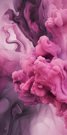 pink and purple ink is mixed together in water, creating an abstract pattern on the surface