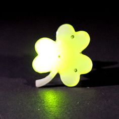 a green light up flower sitting on top of a table