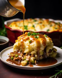 someone is pouring gravy on top of mashed potatoes with green onions and peas